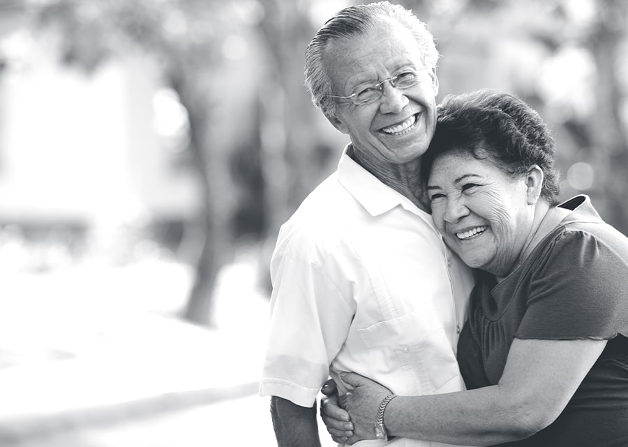 Man and woman smiling while hugging