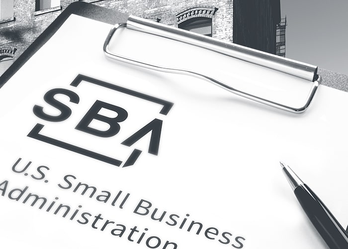 SBA paperwork on clipboard with pen