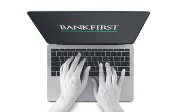 Hands typing on a laptop